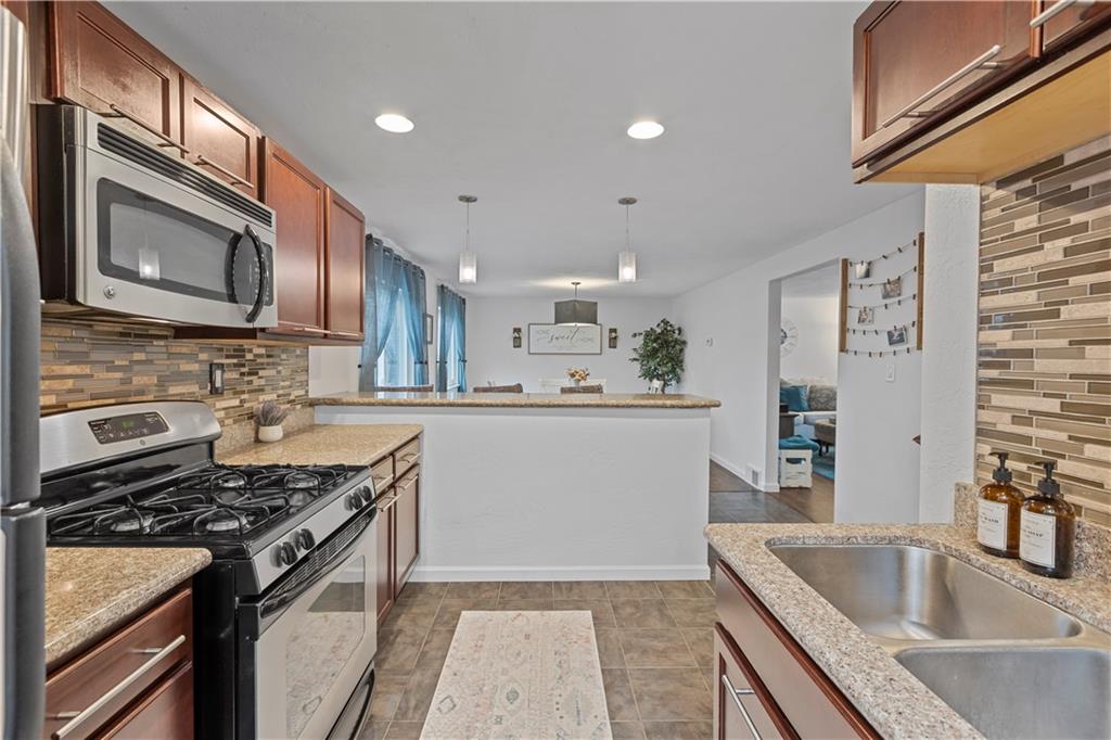 333 Frazier Drive Pittsburgh, PA 15235 - Photo 6 of 22 a kitchen with stainless steel appliances granite countertop a sink stove and refrigerator