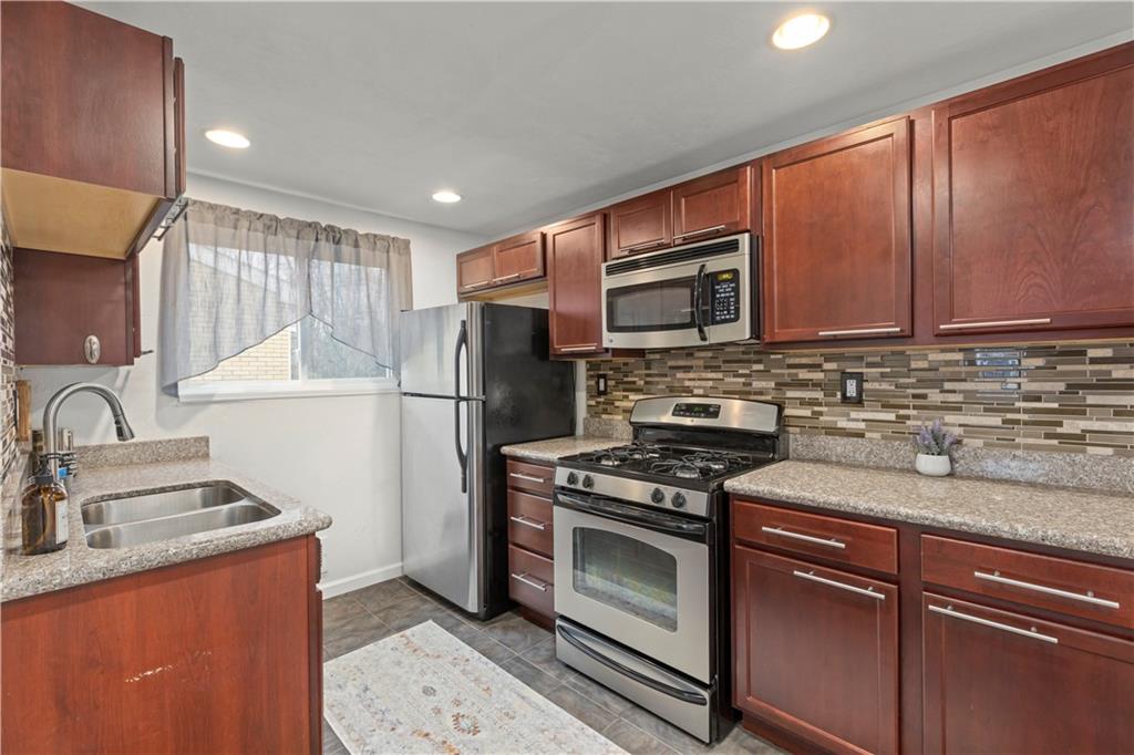 333 Frazier Drive Pittsburgh, PA 15235 - Photo 7 of 22 a kitchen with stainless steel appliances granite countertop a refrigerator stove top oven and sink