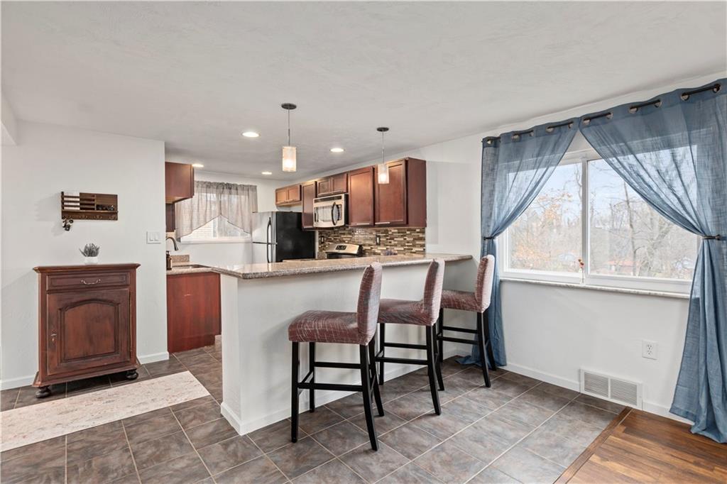 333 Frazier Drive Pittsburgh, PA 15235 - Photo 8 of 22 a kitchen with stainless steel appliances granite countertop a stove a sink a refrigerator and a microwave