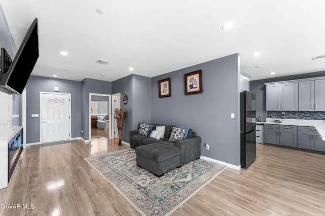 a living room with furniture and kitchen view