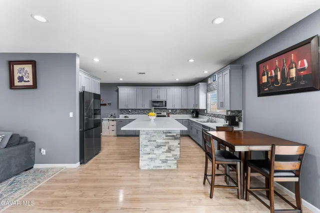 a large kitchen with a table and chairs