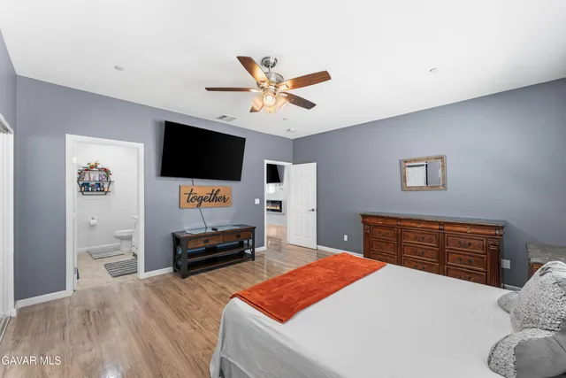 a bedroom with furniture and a flat screen tv