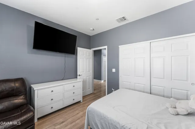 a bedroom with a bed and a flat screen tv