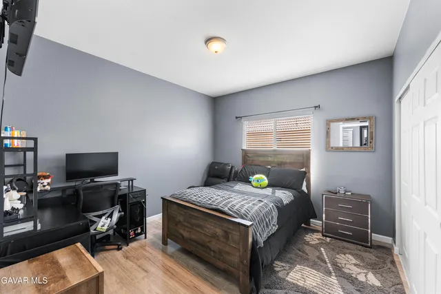 a bedroom with a bed and a tv on the table