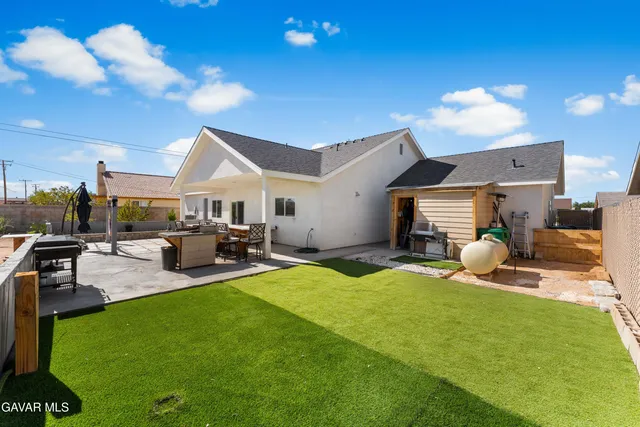 a view of house with outdoor space and sitting area