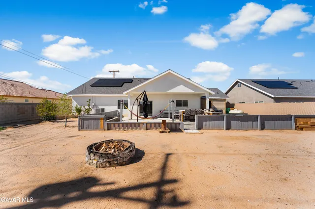 a view of a house with outdoor space and sitting area