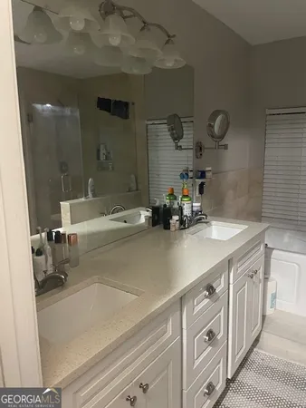 a bathroom with a sink a double vanity and shower