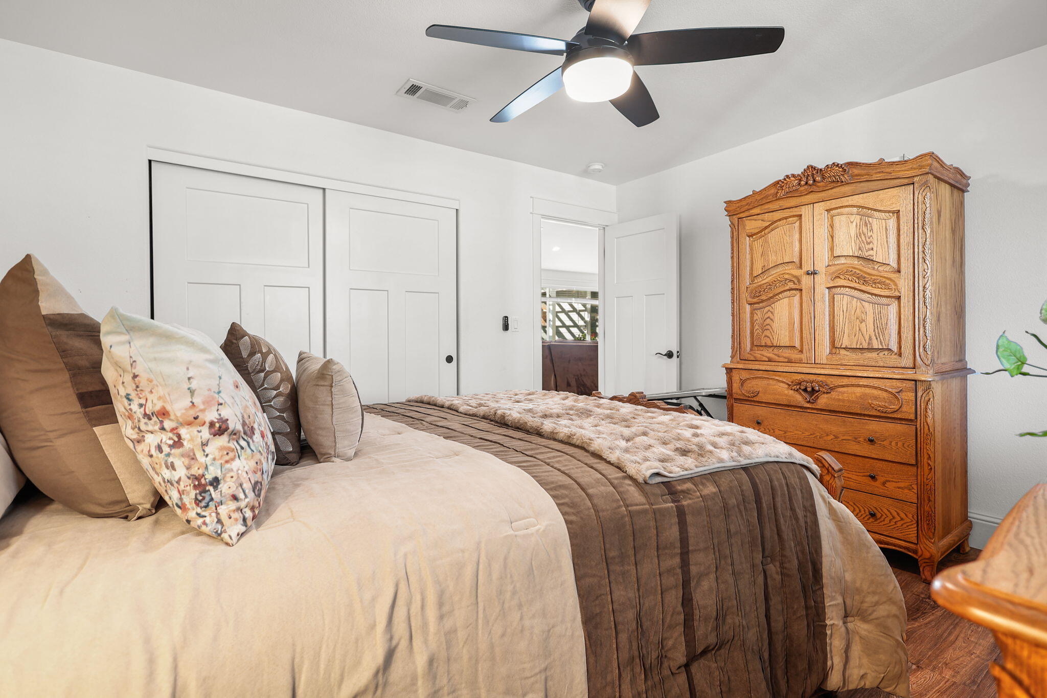 5511 Wilson Hill Road Manton, CA 96059 - Photo 19 of 71 a bedroom with a large bed and a chandelier