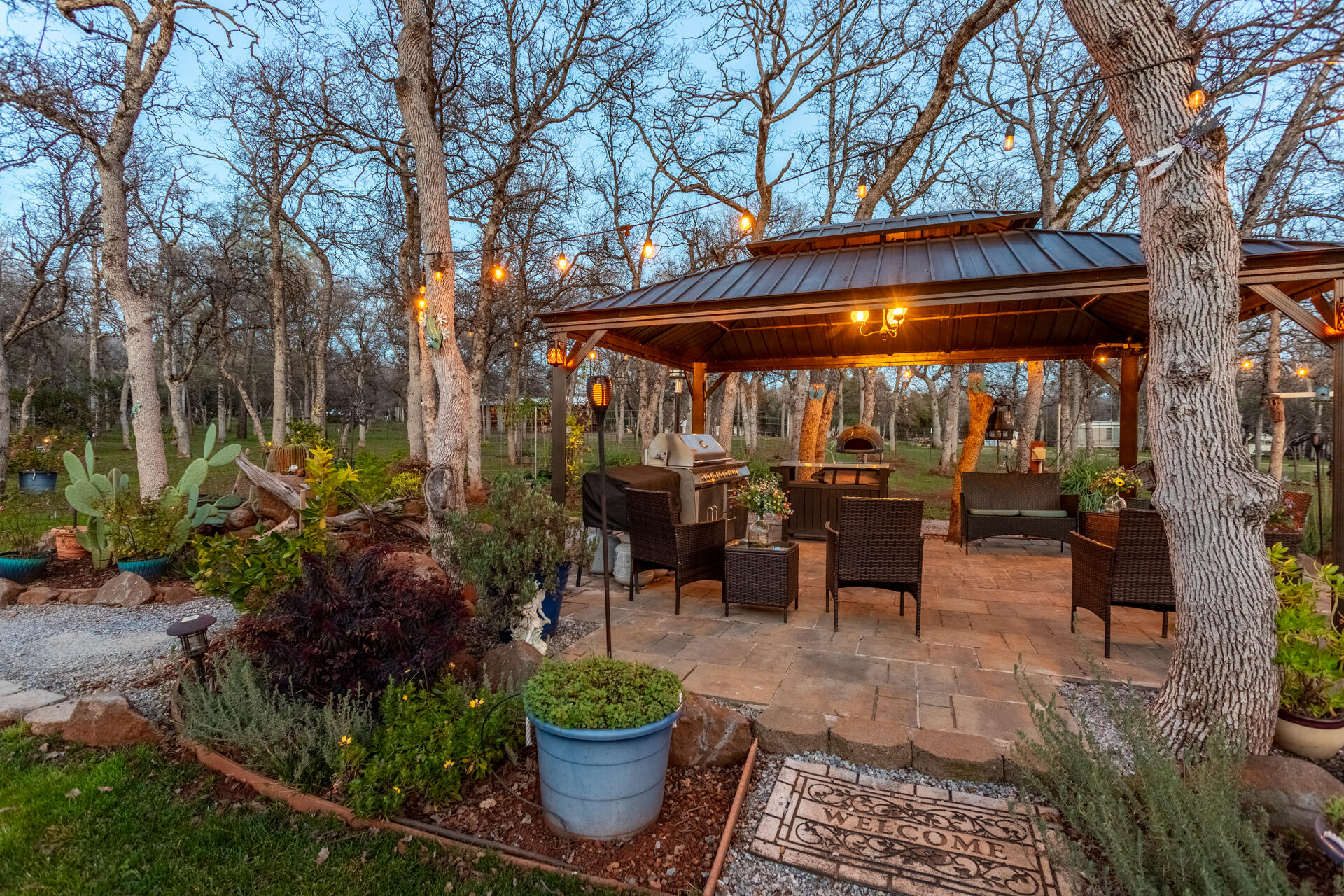 5511 Wilson Hill Road Manton, CA 96059 - Photo 2 of 71 a view of a patio with table and chairs potted plants and large tree
