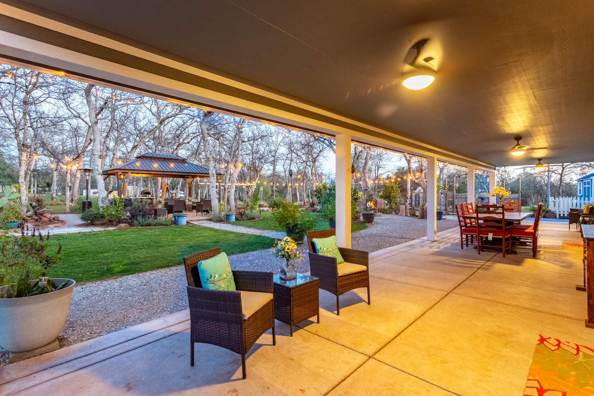 5511 Wilson Hill Road Manton, CA 96059 - Photo 52 of 71 a view of a patio with table and chairs potted plants and a large tree