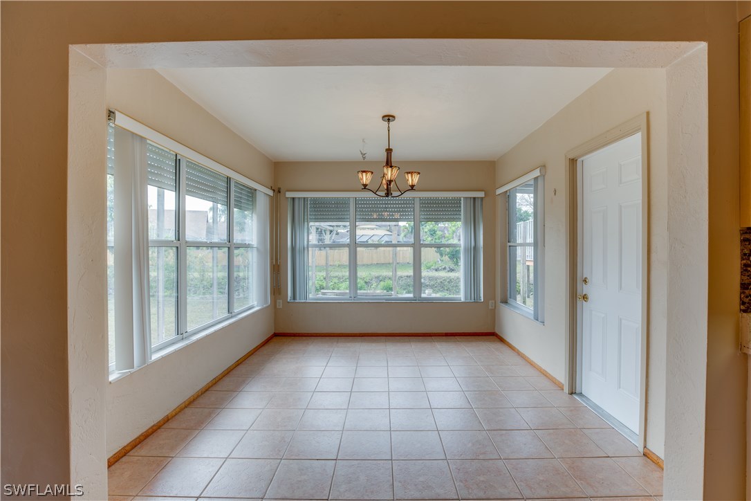 1418 Charles Road Fort Myers, FL 33919 - Photo 6 of 24 a view of an empty room with a window