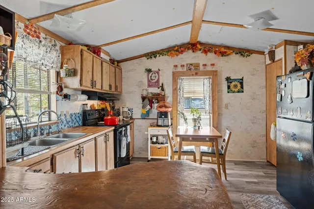 a kitchen with stainless steel appliances granite countertop a refrigerator and a stove top oven