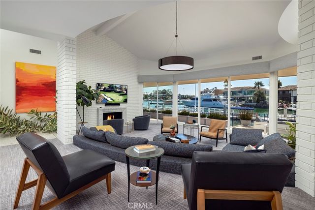 a living room with furniture and a floor to ceiling window