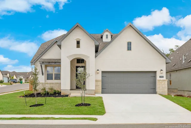 a view of a white house with a yard