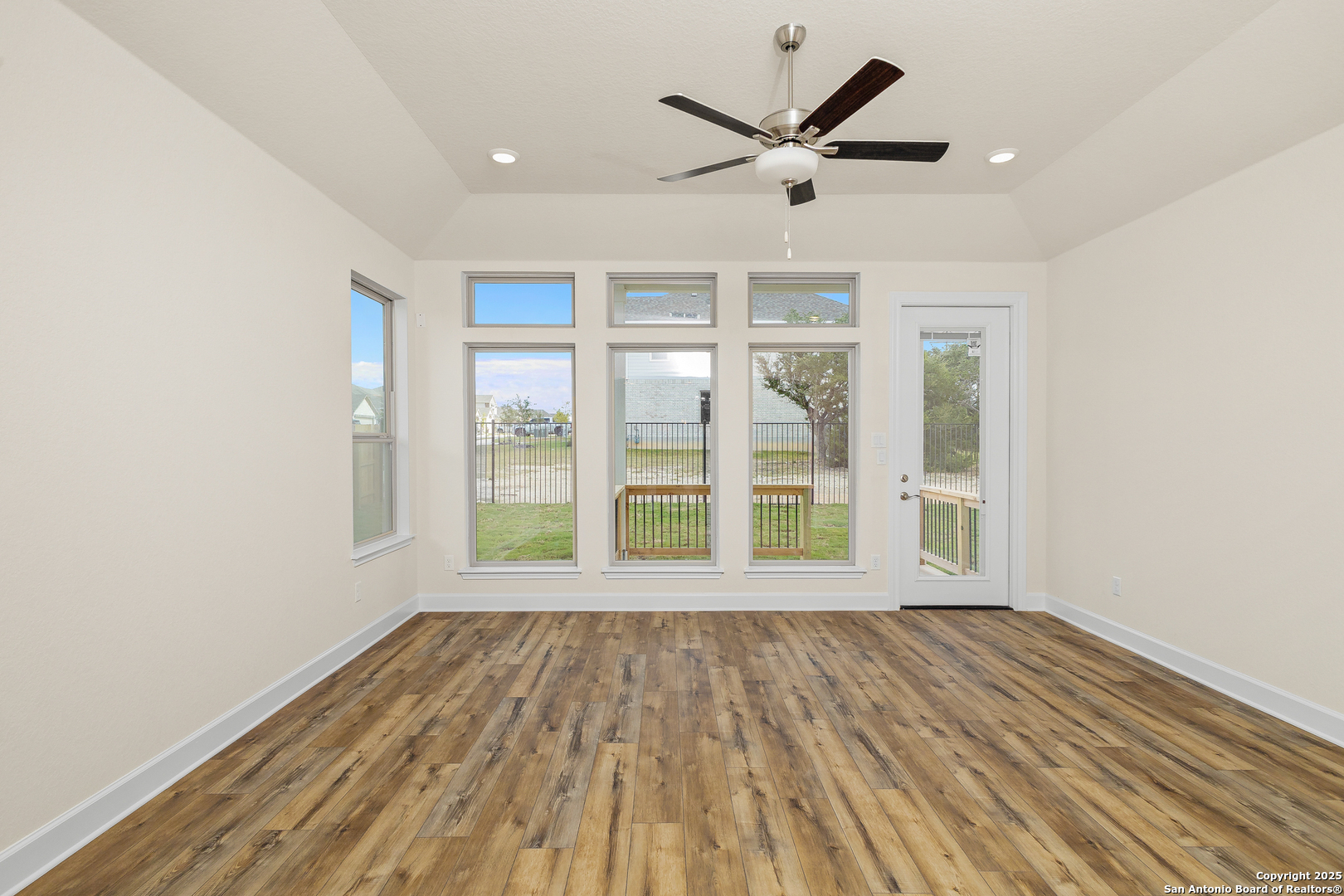 1716 Durham Bulverde, TX 78163 - Photo 11 of 42 an empty room with wooden floor and windows