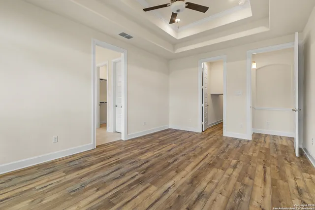 a view of an empty room and wooden floor