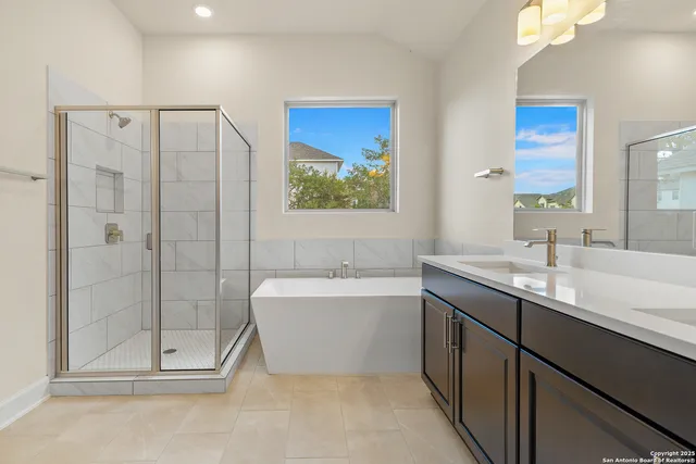 a bathroom with a double vanity sink mirror and bathtub