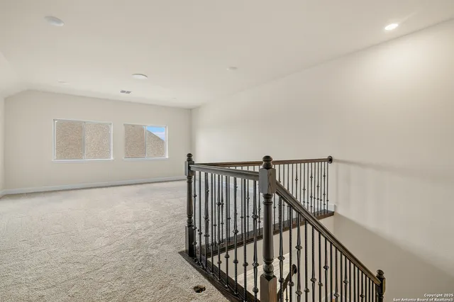 a view of a hallway with wooden floor and entryway