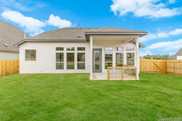 a view of a house with a backyard