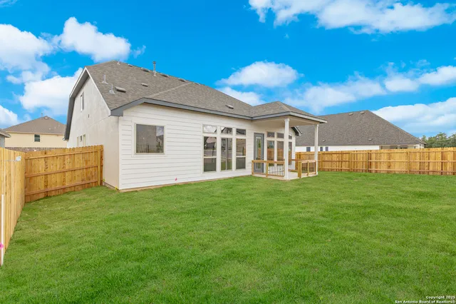 a view of a house with a backyard