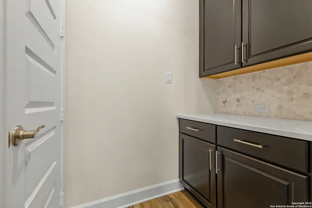 a view of cabinets with wooden floor