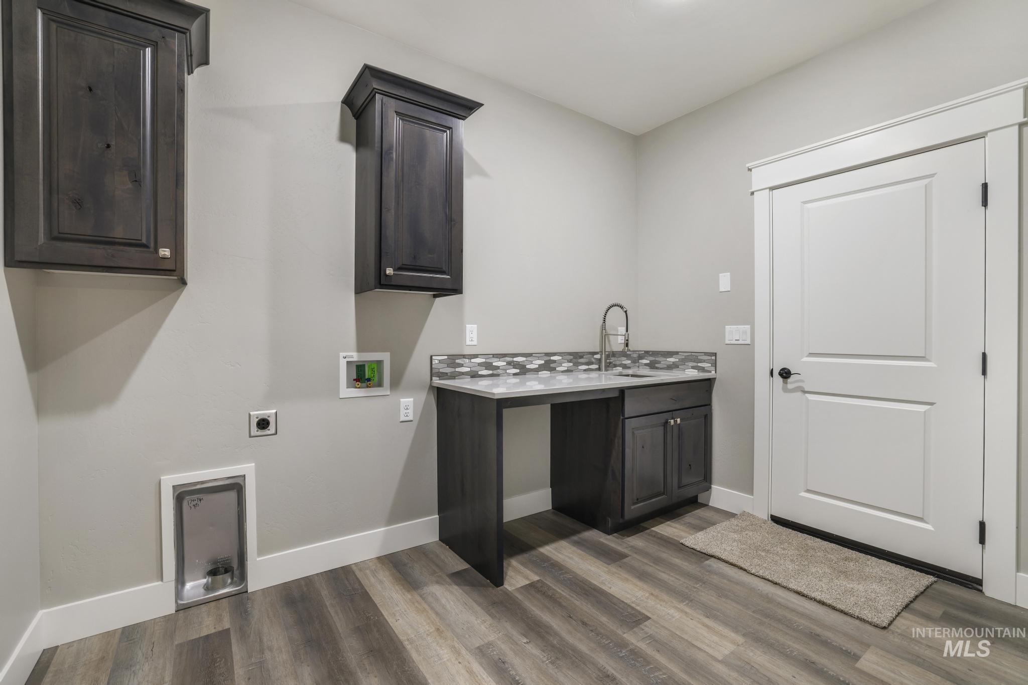 298 Sandi Road Twin Falls, ID 83301 - Photo 11 of 24 Dedicated utility space featuring wood-finish flooring, light grey walls, and white trim