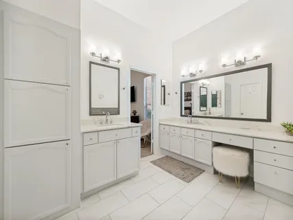 a bathroom with a granite countertop sink mirror and toilet