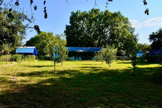 a swimming pool with outdoor seating and yard