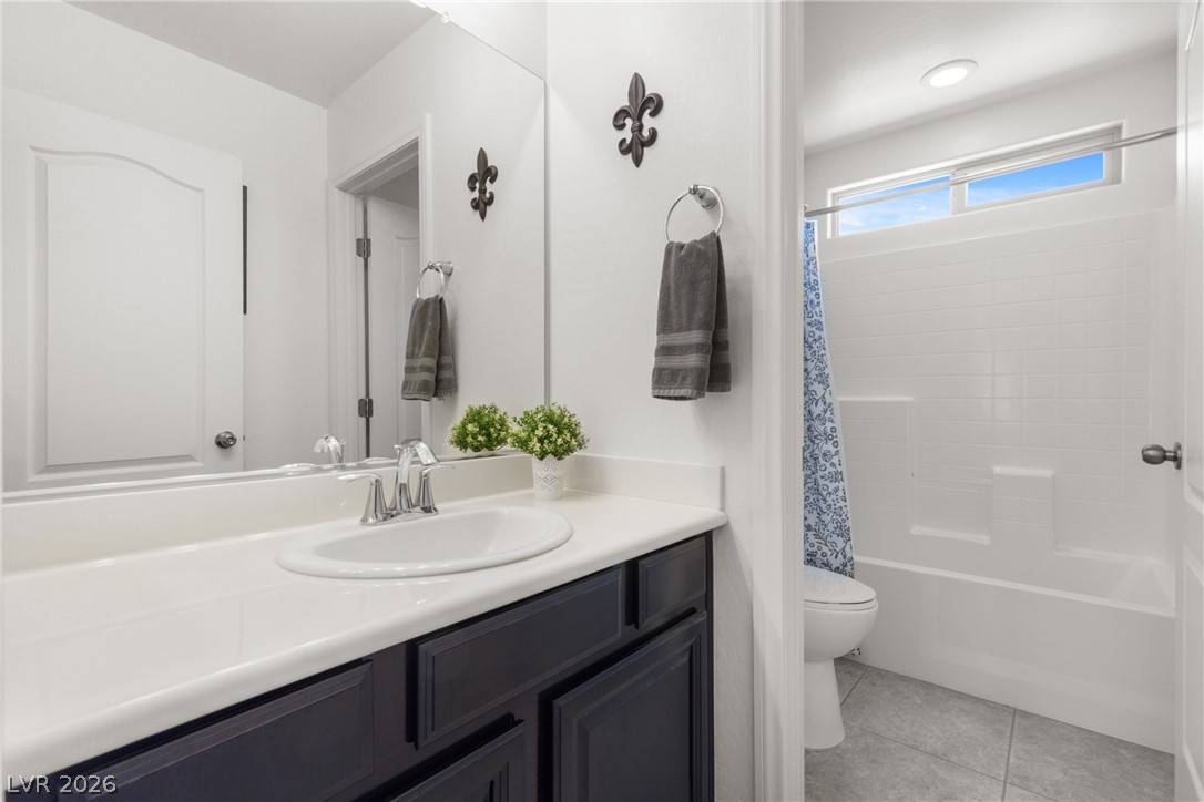 891 Earth Luster Road Las Vegas, NV 89178 - Photo 22 of 48 A well-lit bathroom with a clean, functional vanity and a shower-tub combination.