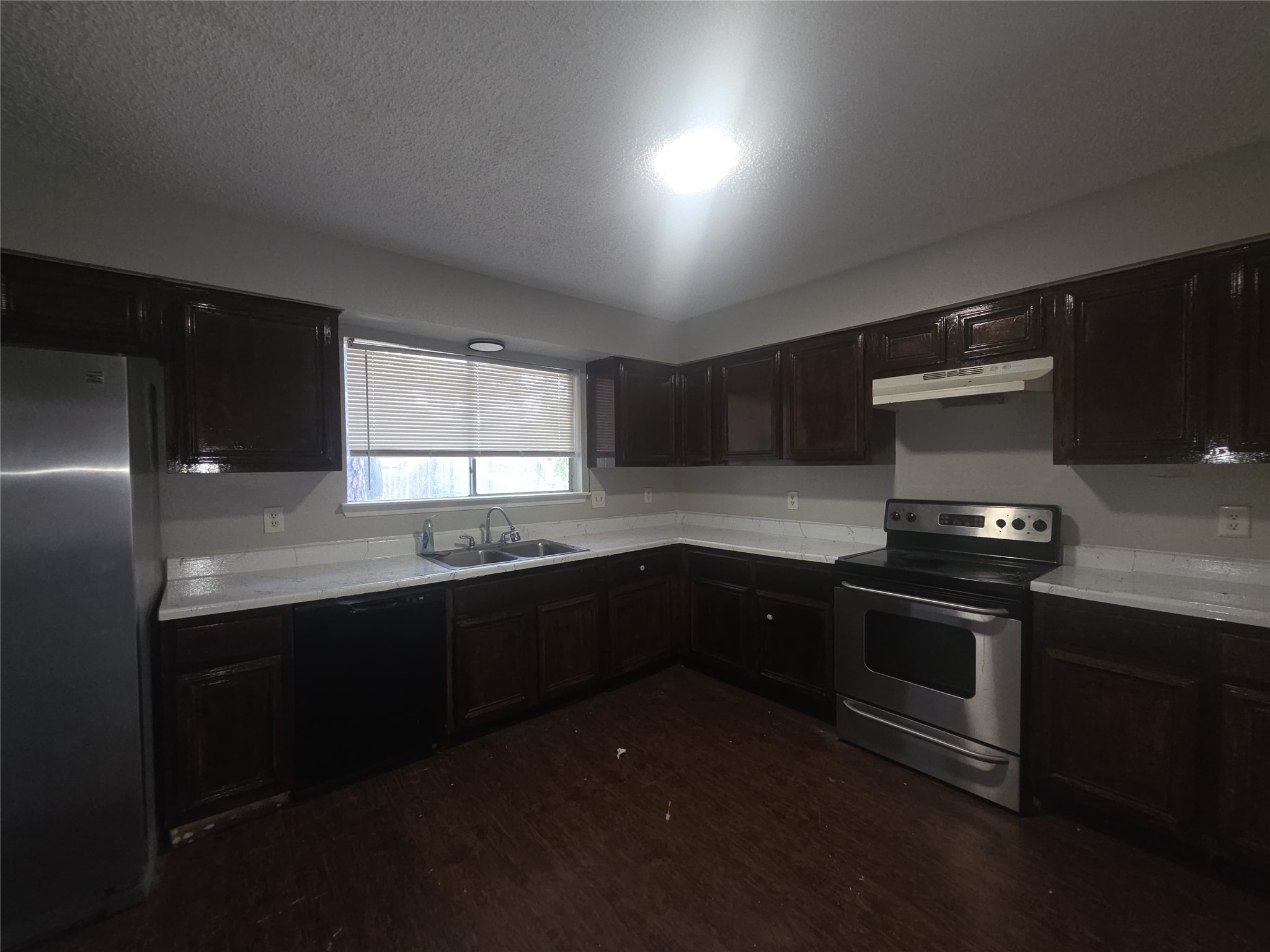 23322 Dew Wood Lane Spring, TX 77373 - Photo 9 of 20 a kitchen with stainless steel appliances granite countertop sink stove and microwave