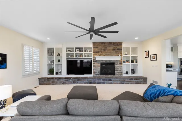 a living room with furniture and a fireplace