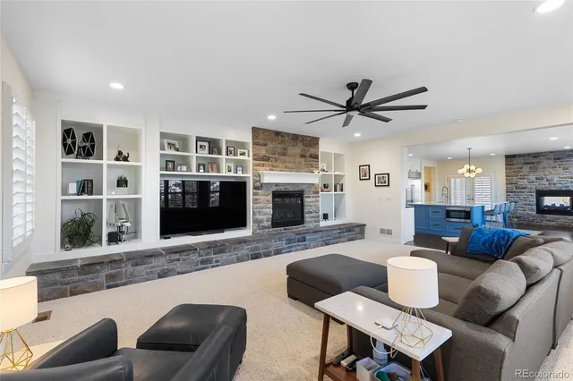 a living room with furniture a flat screen tv and a fireplace