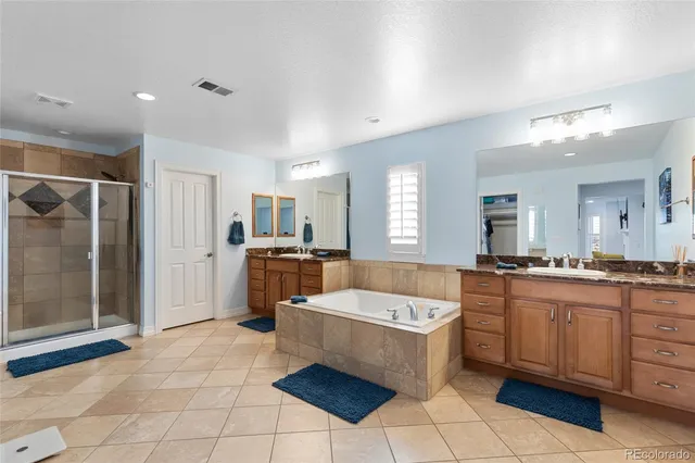 a large kitchen with a large counter top space a sink a window and stainless steel appliances