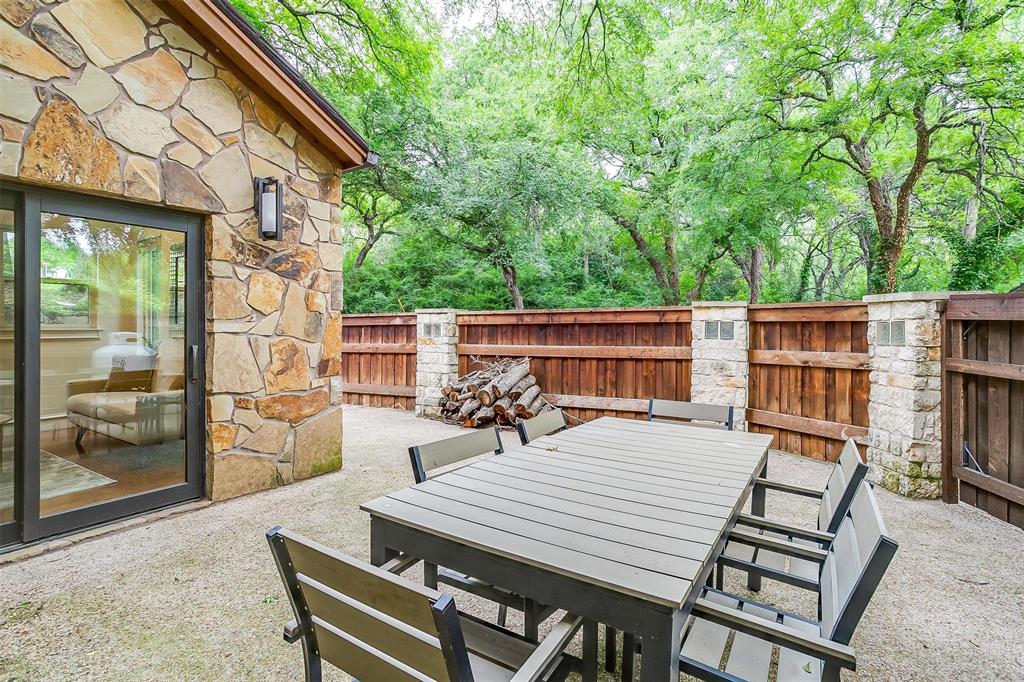 4100 Inwood Road Fort Worth, TX 76109 - Photo 12 of 40 a view of a patio with table and chairs with wooden floor and fence