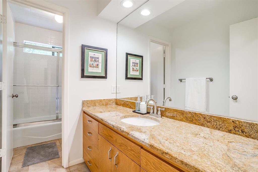 4100 Inwood Road Fort Worth, TX 76109 - Photo 23 of 40 a bathroom with a granite countertop sink a mirror and a shower