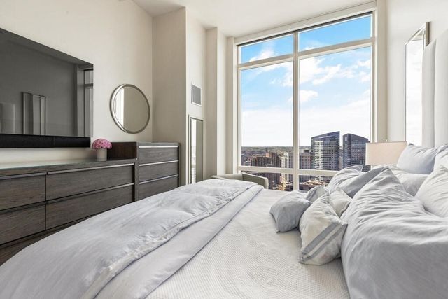 a bedroom with a large bed and a large window