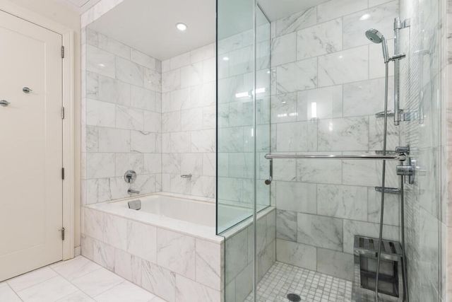 a bathroom with a bathtub and a shower