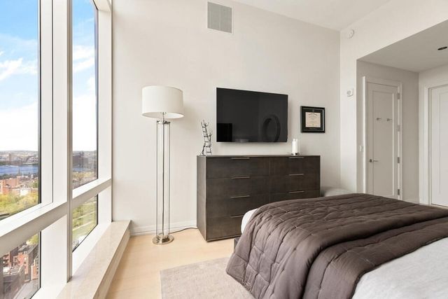 a bedroom with a bed and a flat screen tv