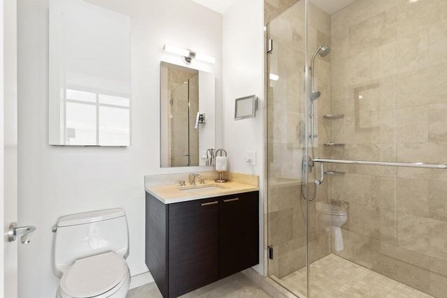 a bathroom with a sink toilet and shower