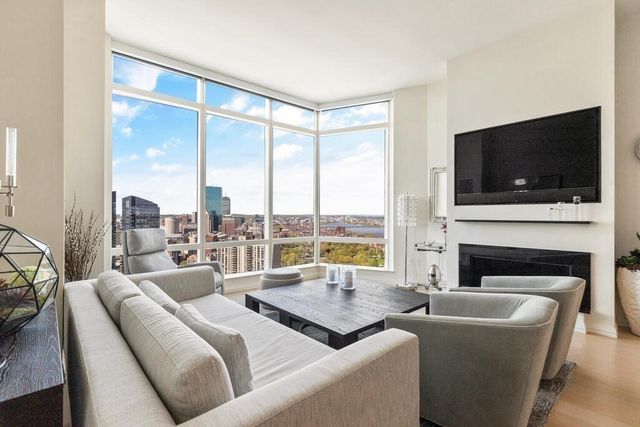 a living room with a fireplace and a flat screen tv