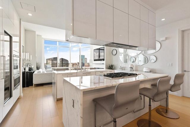 a kitchen with a stove a sink and a refrigerator