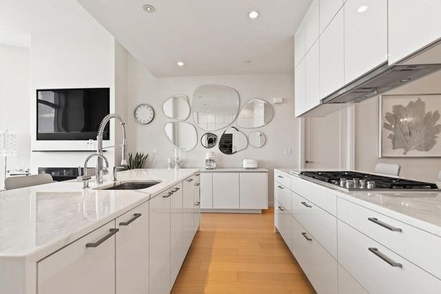 a kitchen with a sink stove and cabinets