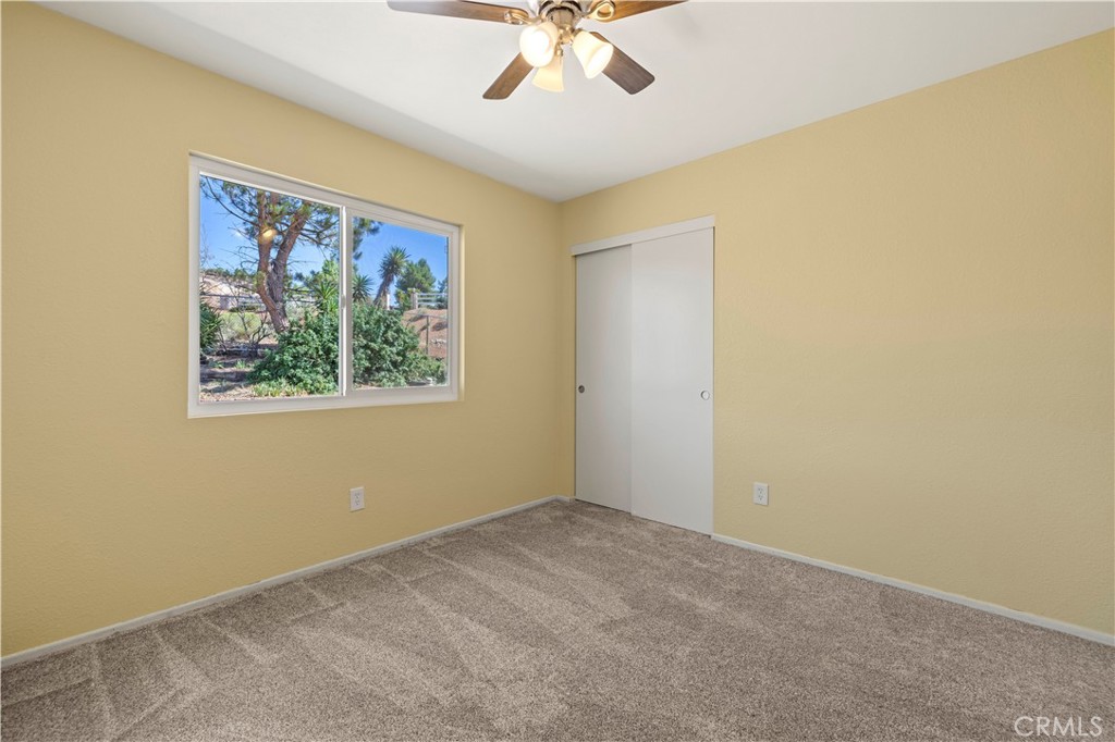 33533 Santiago Road Acton, CA 93510 - Photo 12 of 36 an empty room with a window and a ceiling fan