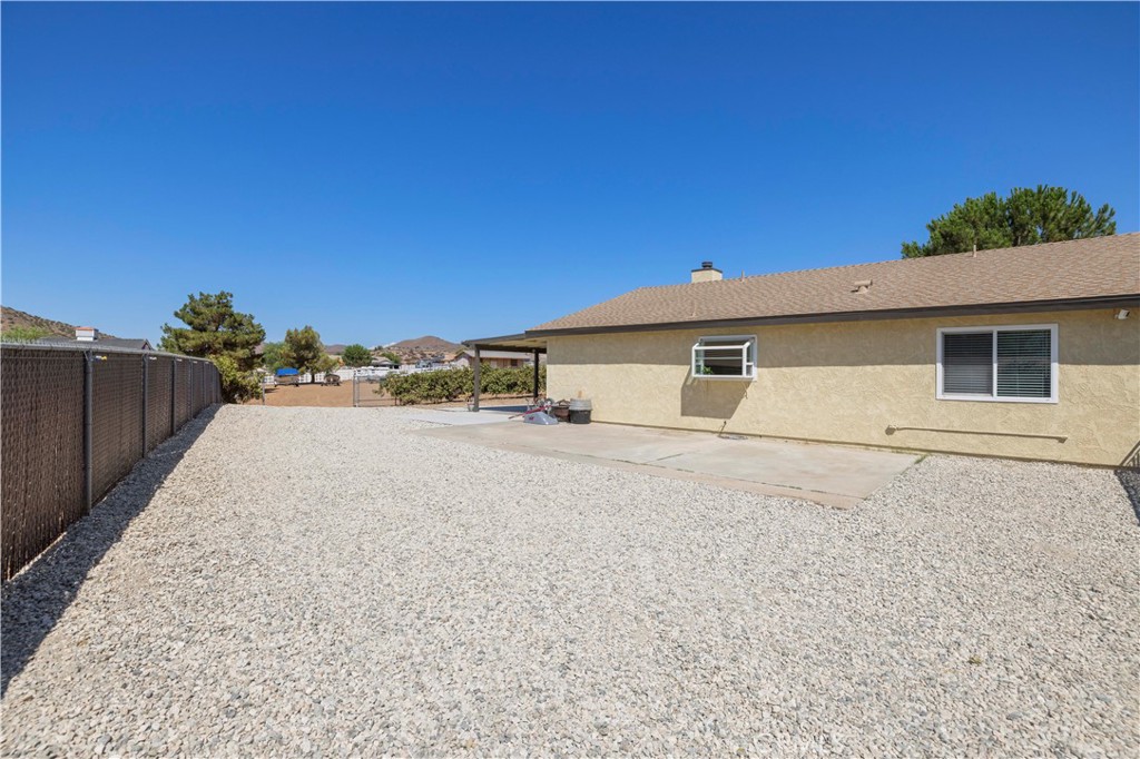33533 Santiago Road Acton, CA 93510 - Photo 27 of 36 a front view of a house with a yard and garage