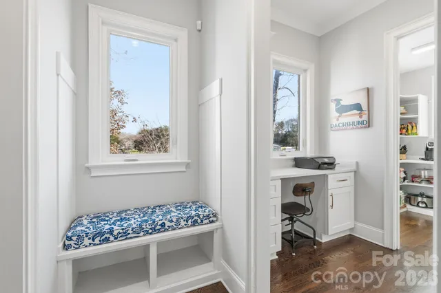 a workspace with furniture a window and a bookshelf