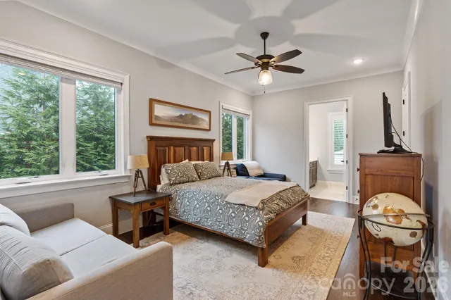 a bedroom with a large bed a couch and a window