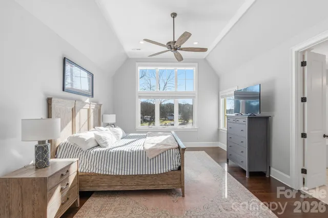 a spacious bathroom with a granite countertop sink mirror and bathtub