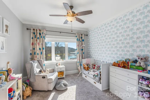 a bathroom with a granite countertop sink a toilet a mirror and shower