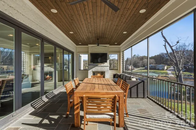a dining room with furniture a fireplace and a chandelier
