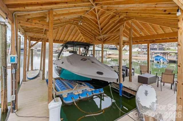 a patio with water view fountain with table and chairs under an umbrella